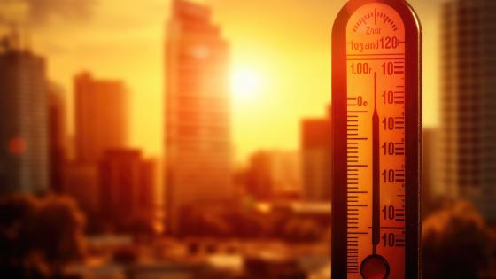Thermometer in Front of City Skyline